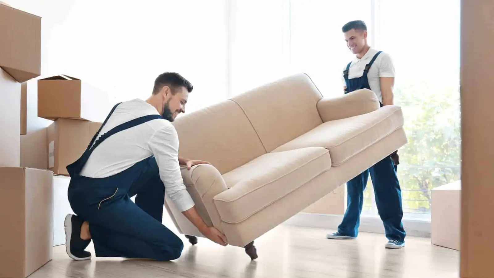 Professional movers carrying furniture during a local residential move