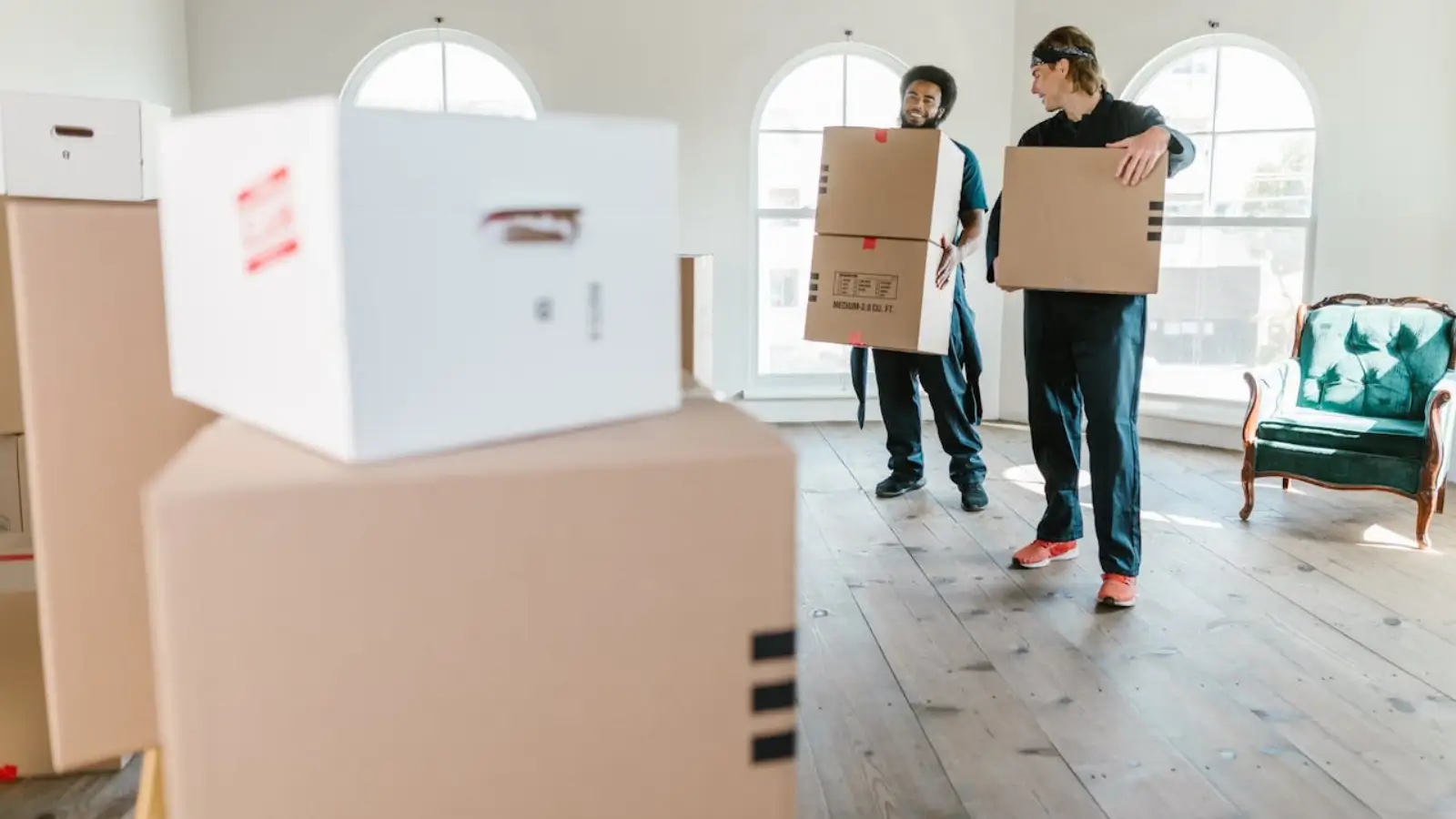 Professional movers unloading boxes during a smooth East London relocation