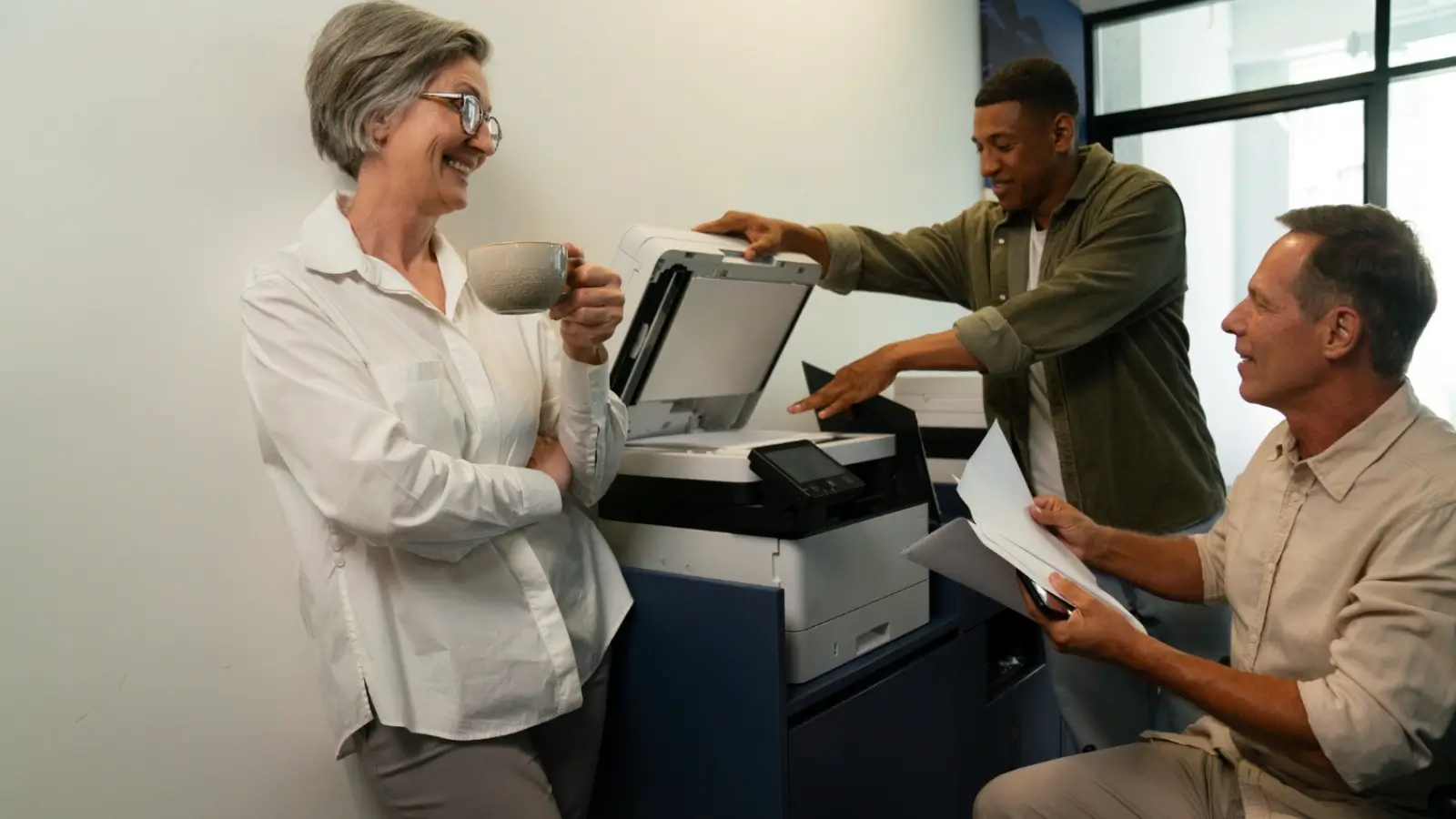 Professional printing team using high-speed commercial printer in a print shop