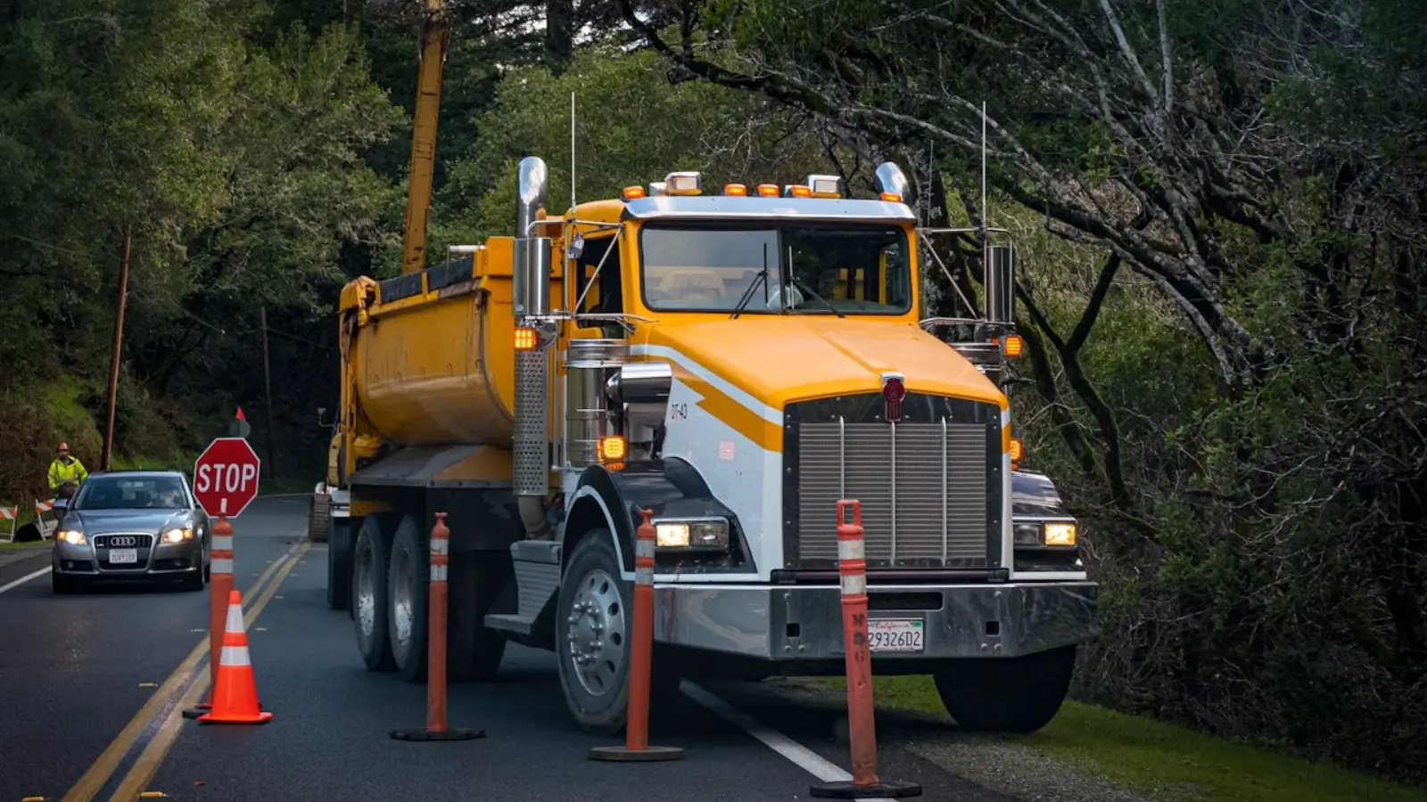 Roadside assistance technician helping a stranded truck on a highway