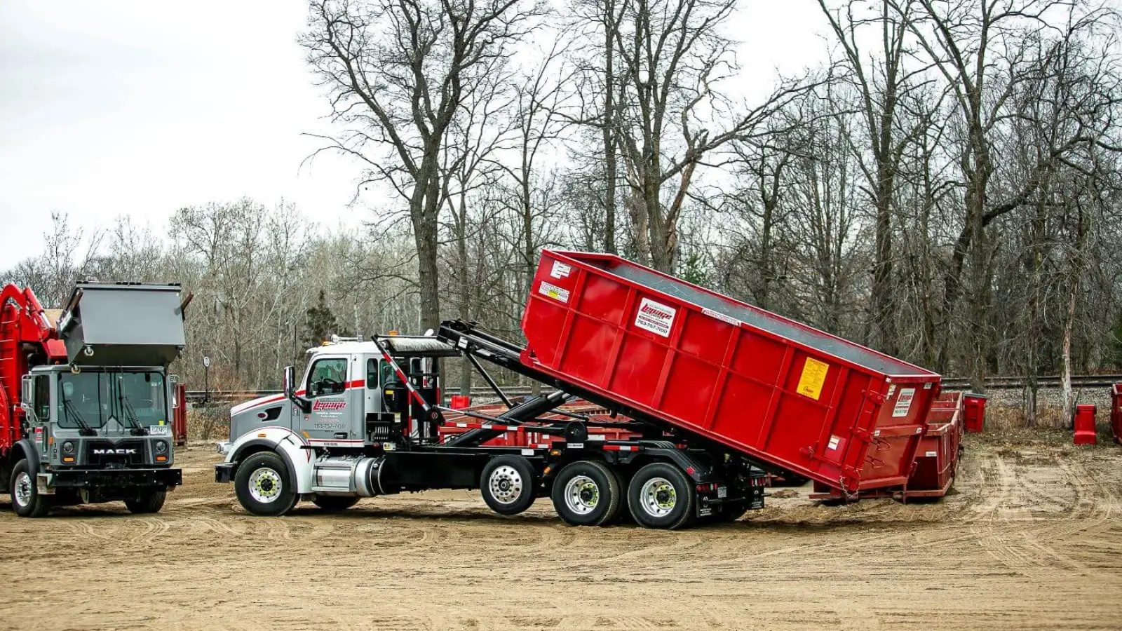 Same-day dumpster rental truck arriving at construction site