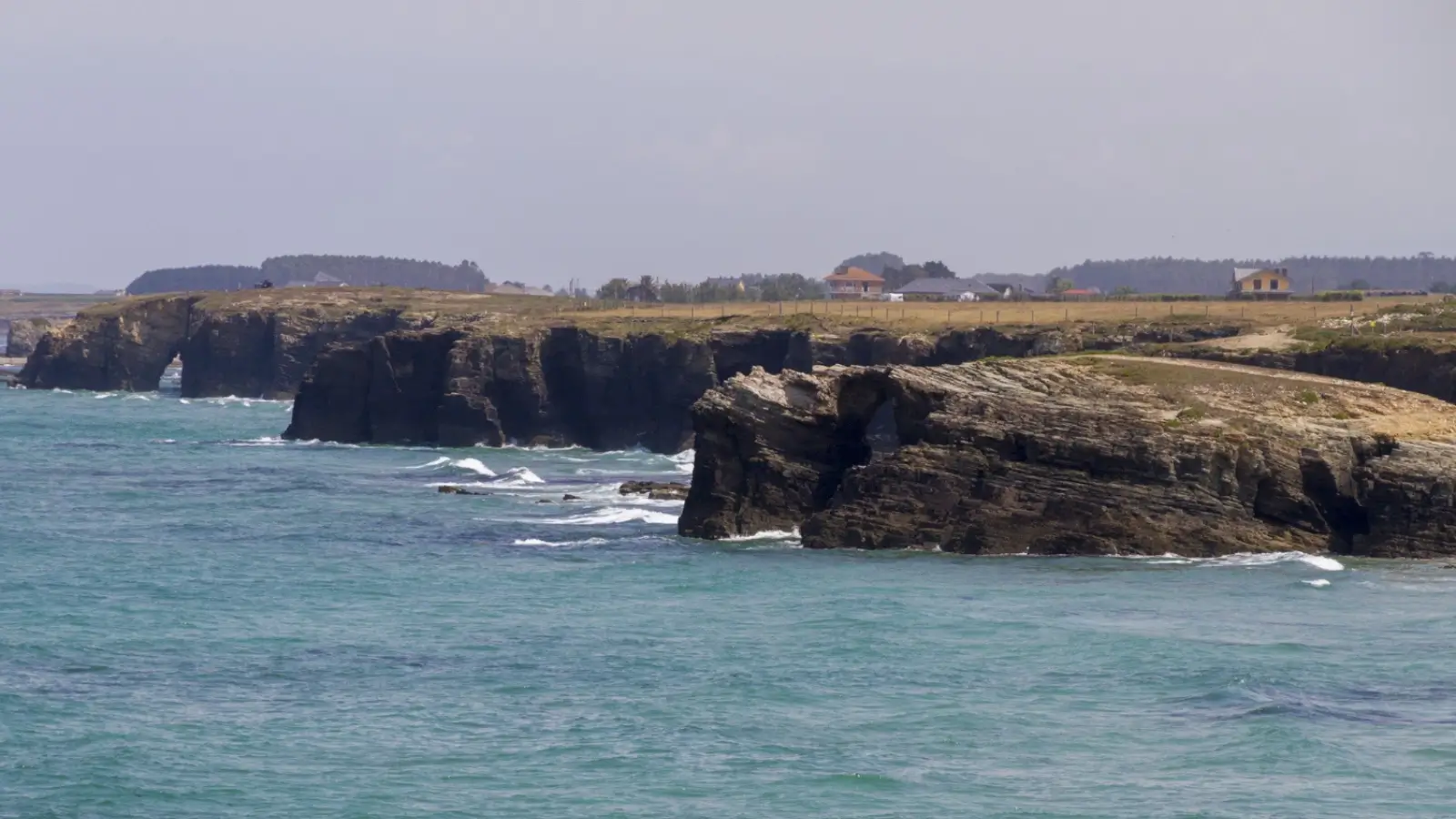 Scenic coastal view of Flinders Island with nearby cottages and rugged landscapes