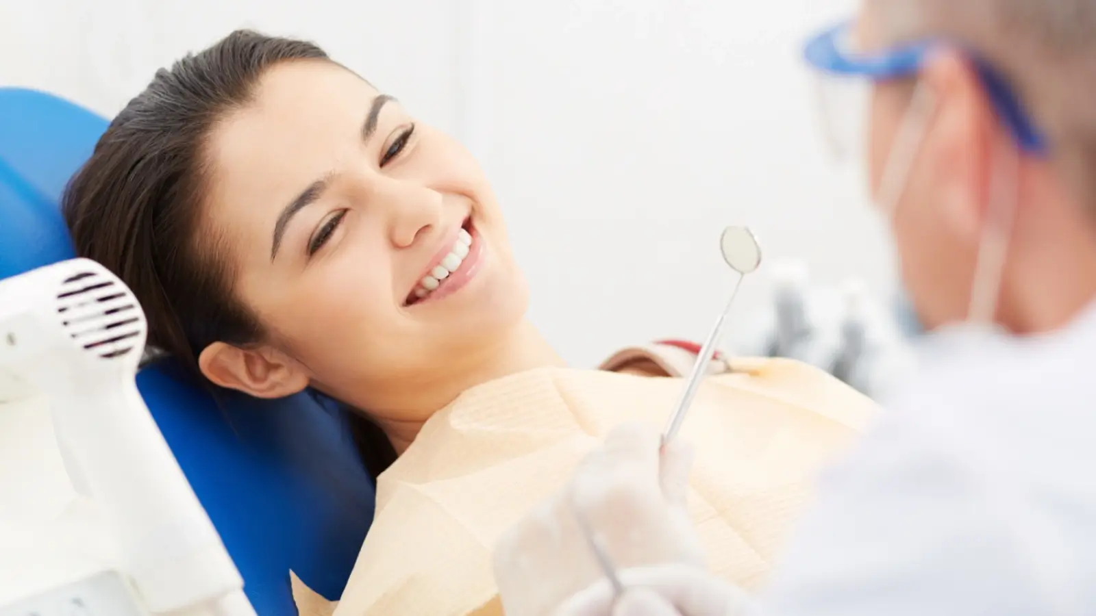 Smiling person after a dental checkup showing healthy white teeth