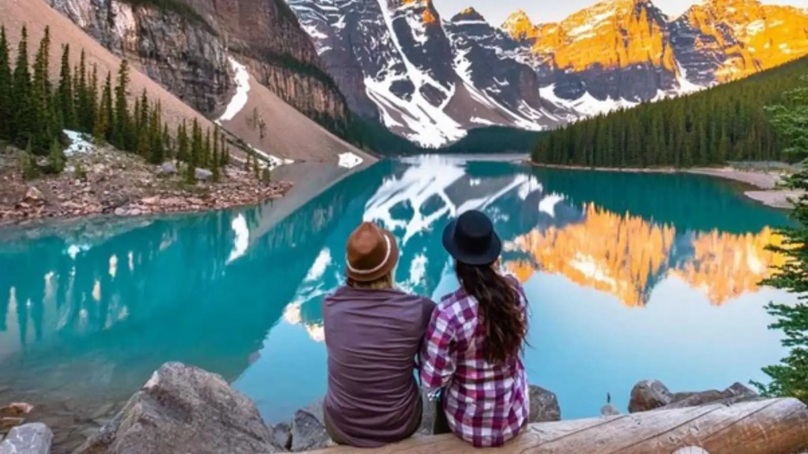 Sunrise over Moraine Lake with golden peaks reflecting in turquoise water