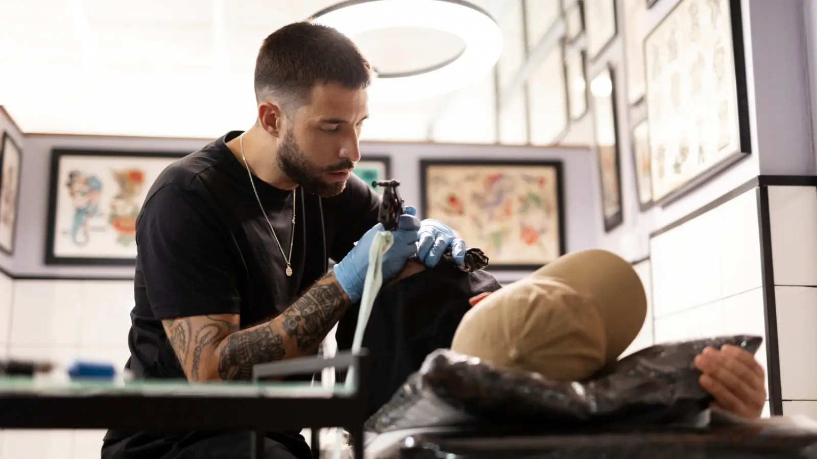 Tattoo artist working on a custom design at Iris Tattoo & Piercings Nashville studio