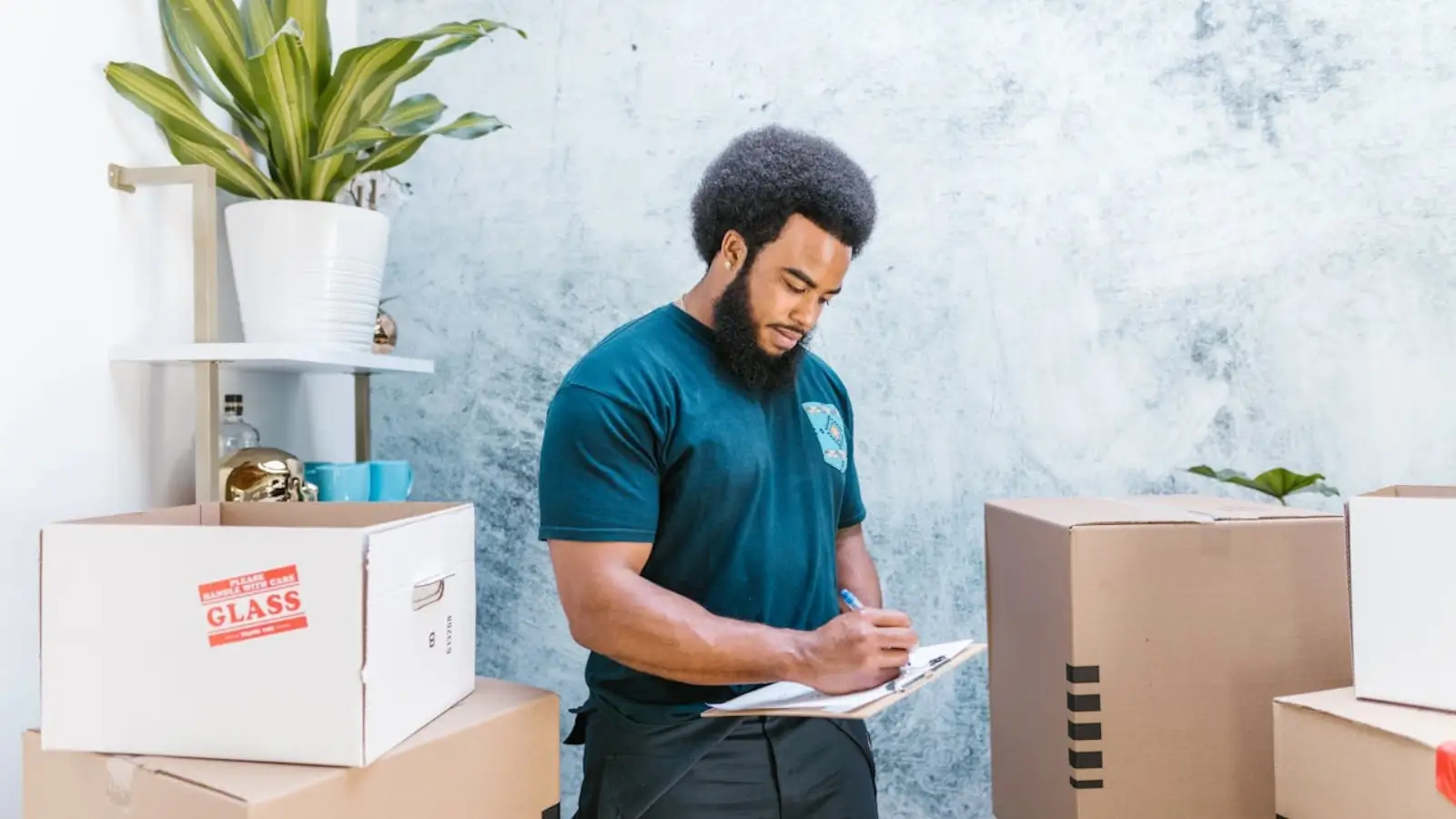 Team organizing an office relocation with labeled boxes and moving checklist