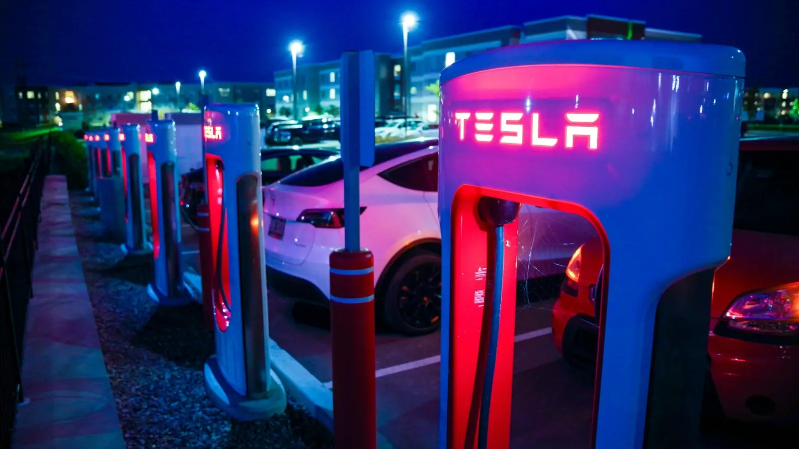 Tesla charging at a high-speed supercharger station on the road
