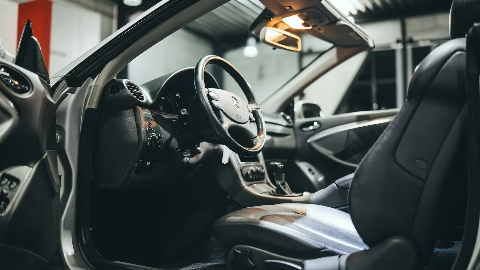 Tradie checking under the bonnet of a work ute during routine maintenance