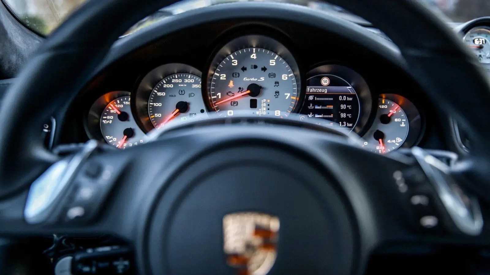 Used Porsche auto parts organized in a garage, ready for vehicle repairs