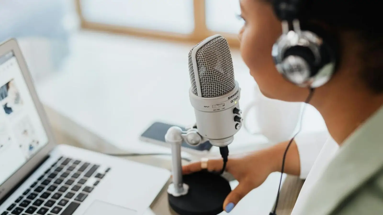 Voice actor recording audio content in a professional studio setup