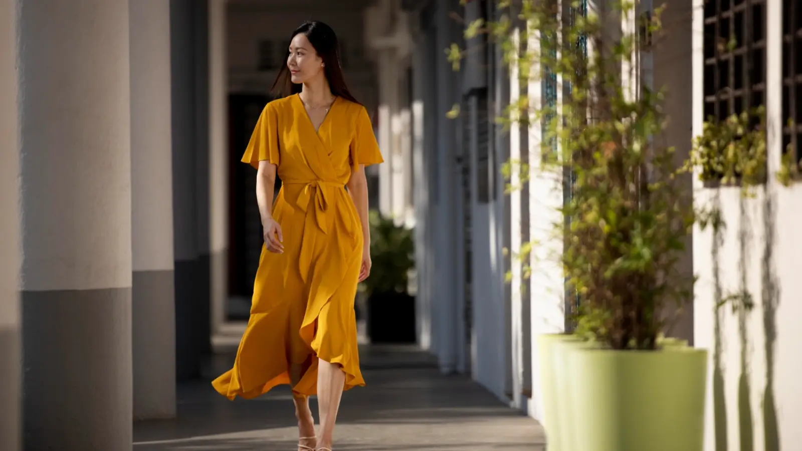Woman wearing a flattering maxi dress walking confidently outdoors
