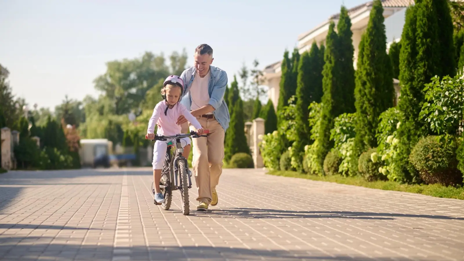 Young family exploring a family-friendly urban neighborhood with parks and cafes