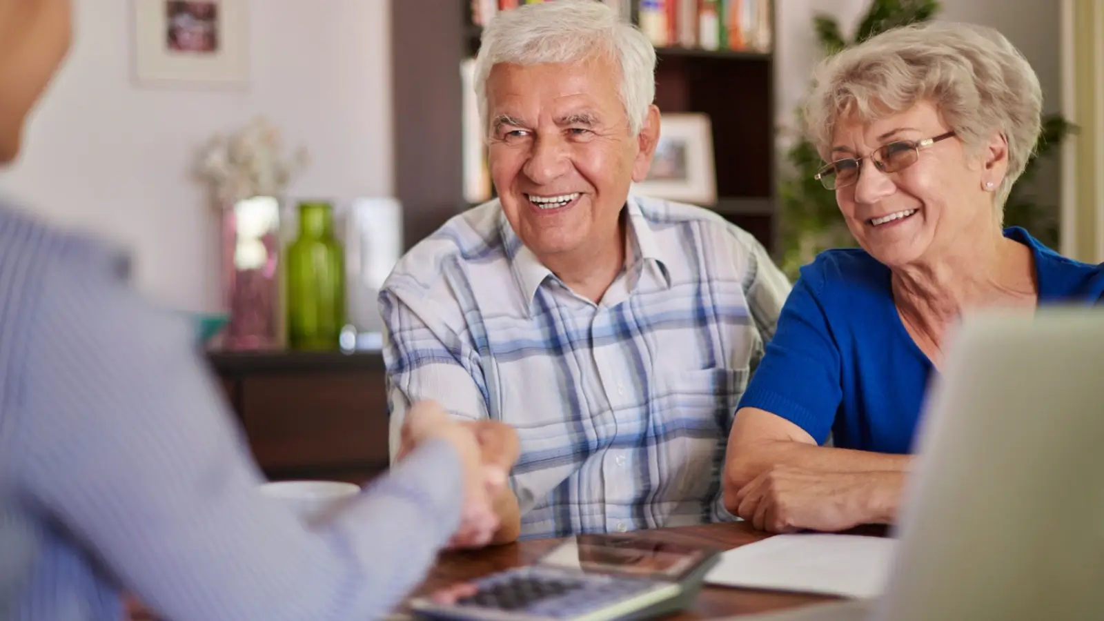 Australian couple reviewing retirement superannuation options with financial advisor.