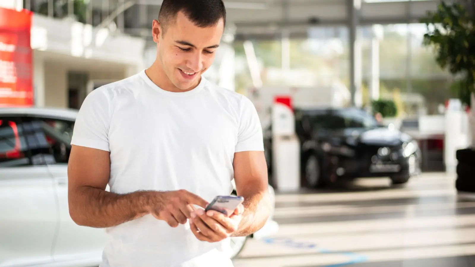 First-time car owner using a mobile app to buy and manage car insurance online.