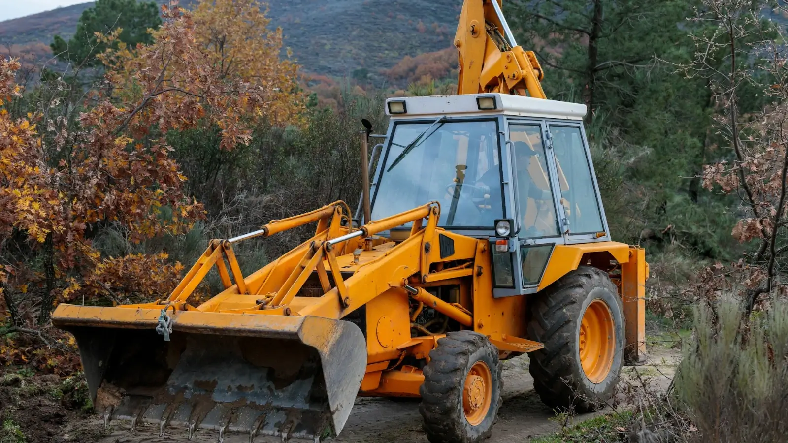 Heavy machinery clearing trees and brush from a construction site during land development