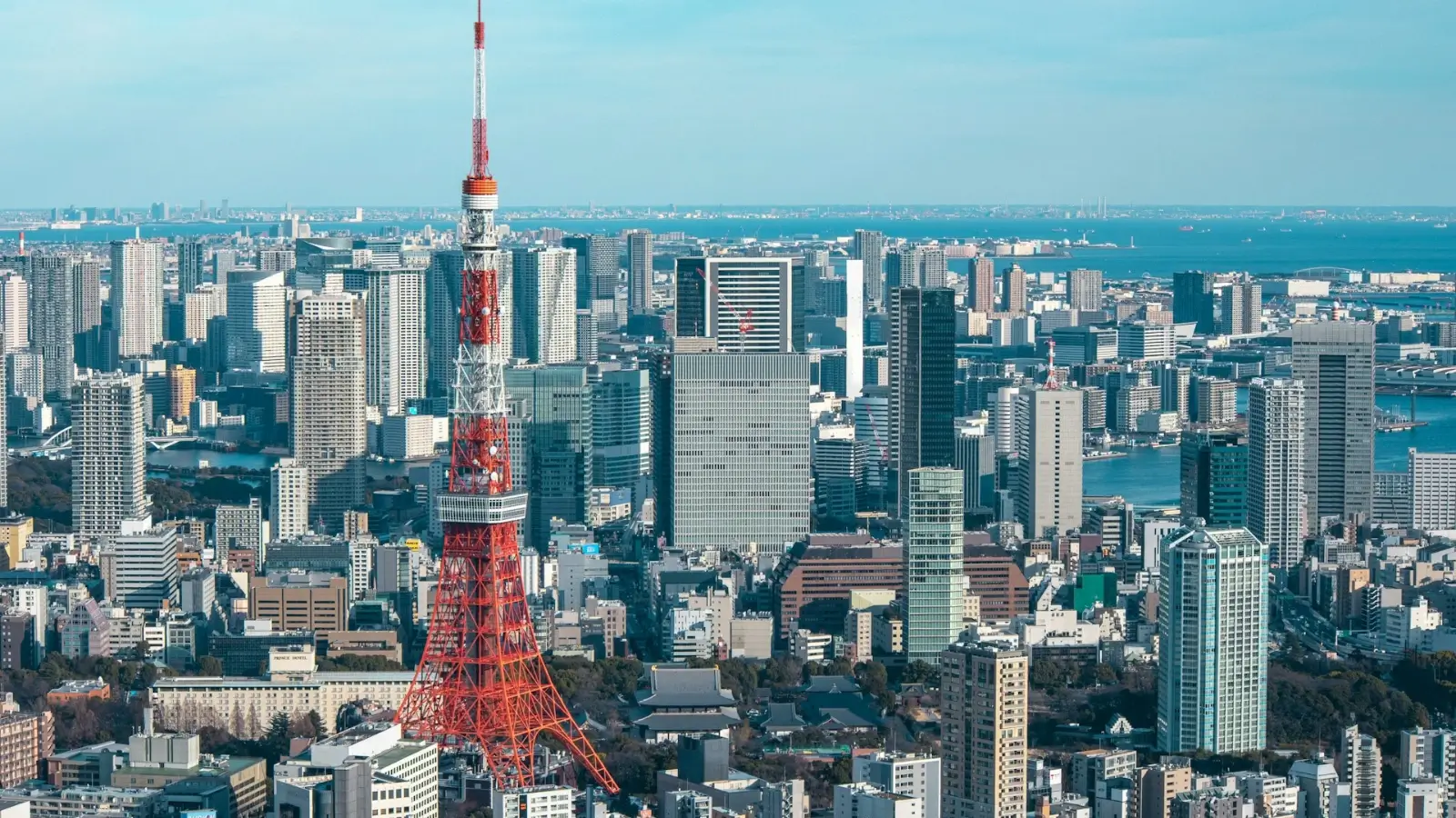 Japanese home alongside modern Tokyo skyline representing real estate contrast