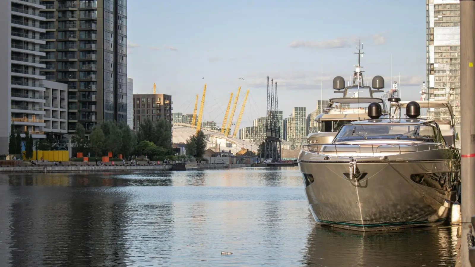 Luxury superyacht docked at a modern Caribbean marina during sunset