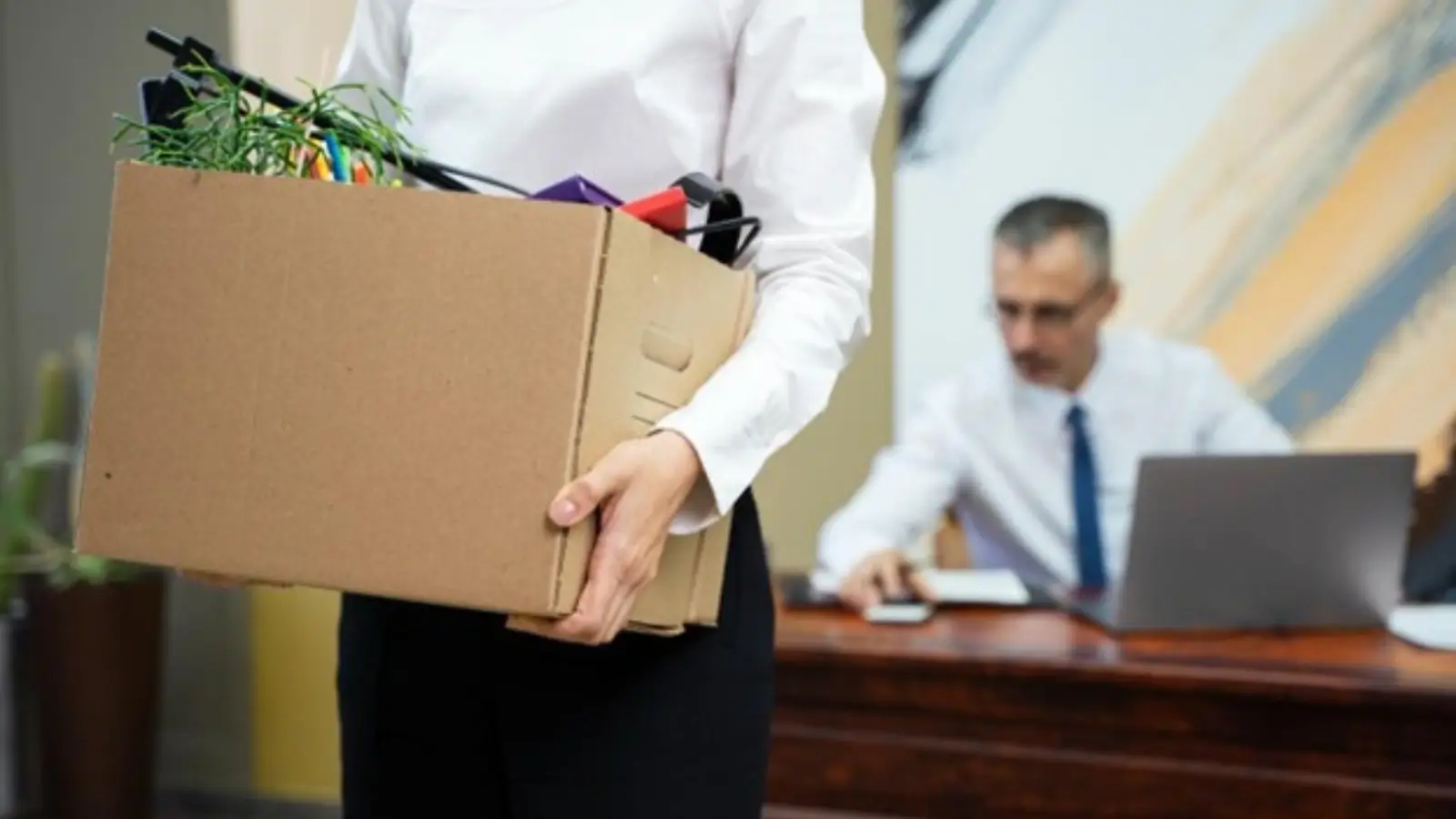 Office furniture removal team cleaning and dismantling workstations during corporate relocation