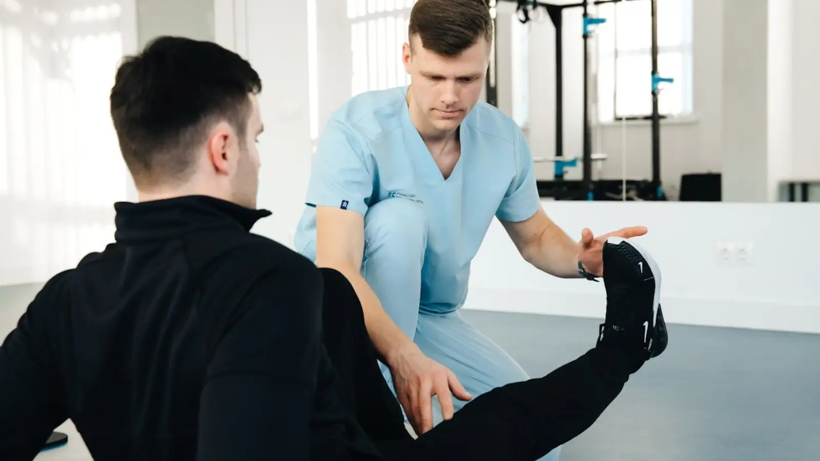 Physical therapist assisting patient with strength training in San Diego clinic