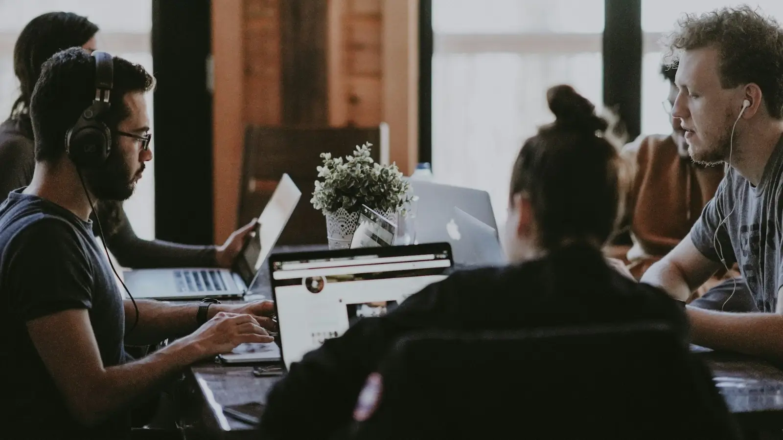 Professional seated at a desk, appearing calm and focused, symbolizing personal stability at work.