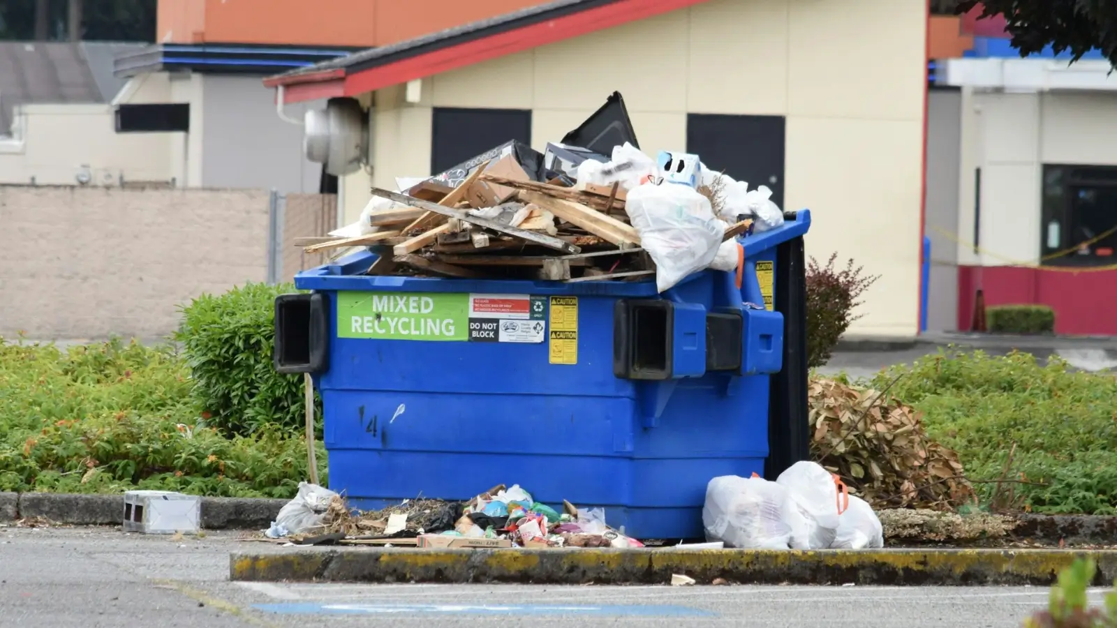 Roll-off construction dumpster filled with debris at a building site