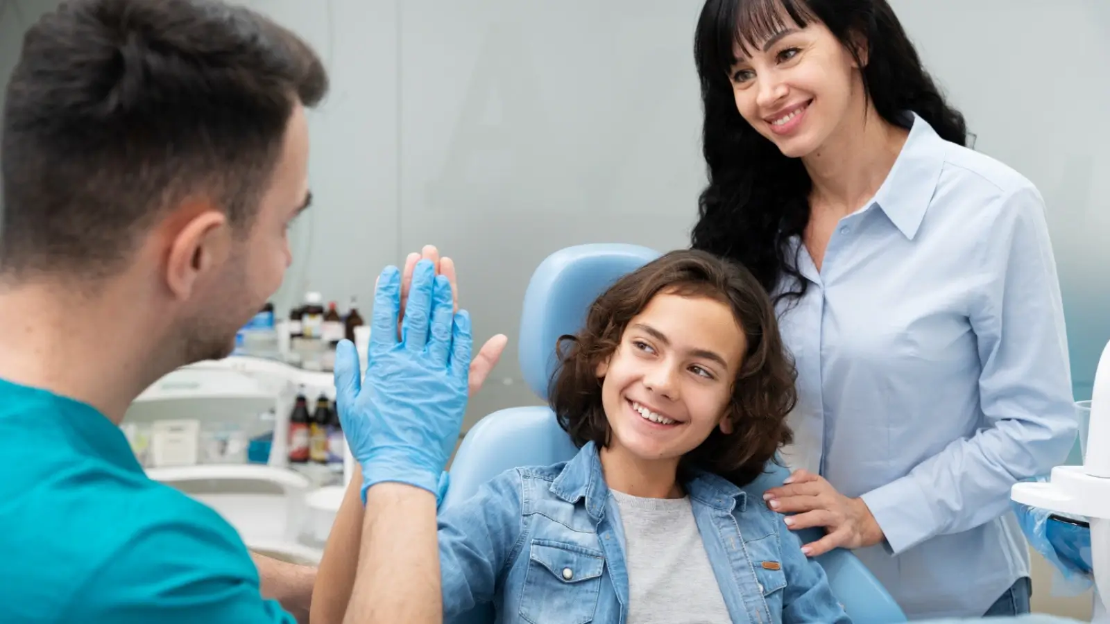 Smiling family visiting a trusted dentist in Willmar for routine checkups