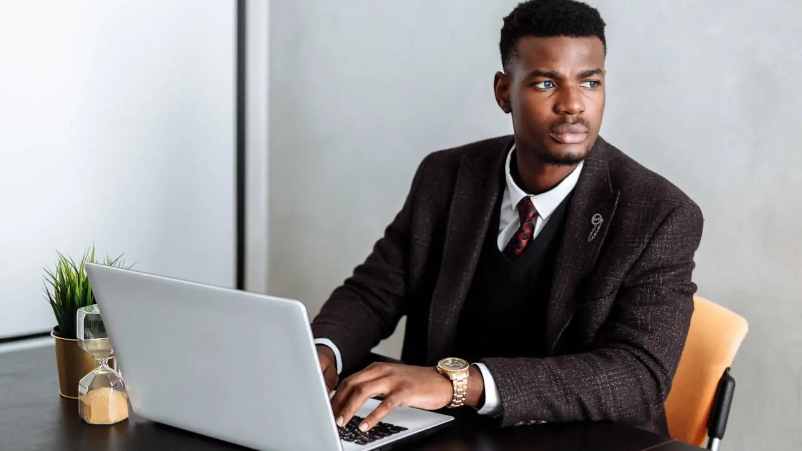 Entrepreneur reviewing business formation steps on a laptop with legal documents