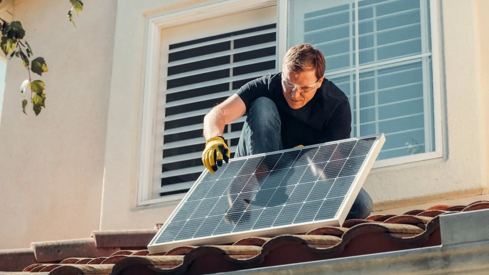 The Do’s and Don’ts of Home Solar Installation Technician installing rooftop solar panels on a residential home under clear skies