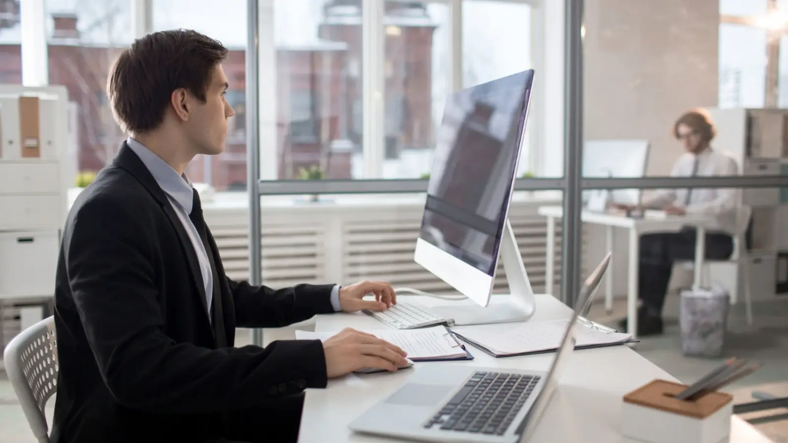 Employee using AI learning platform on laptop in modern office setting