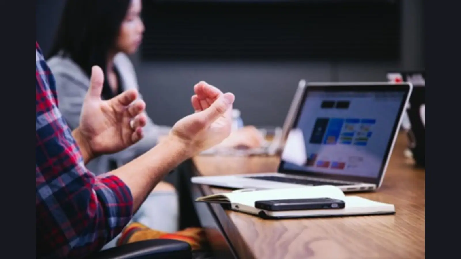 Team member in a meeting using a computer with an AI integration system to explore the role of AI in streamlining business processes