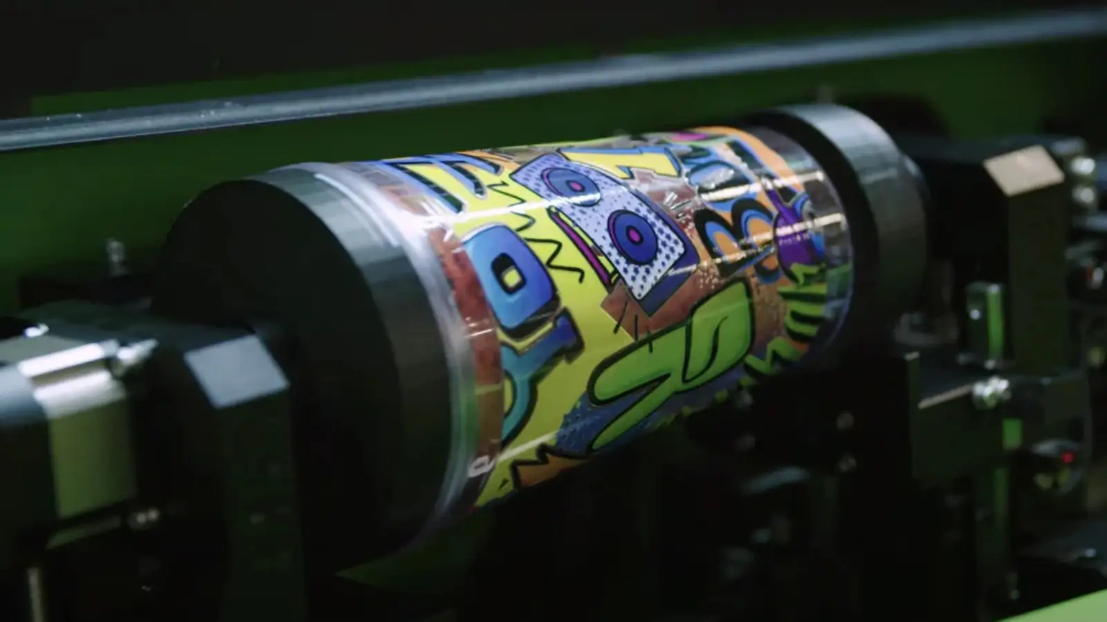 Cylindrical printer creating 360-degree custom packaging design on bottles