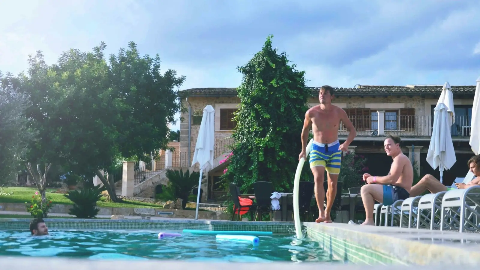 Why Should Your Next Group Trip Be a Private Villa Stay? Friends enjoying a group vacation in a private luxury villa with pool and shared living space