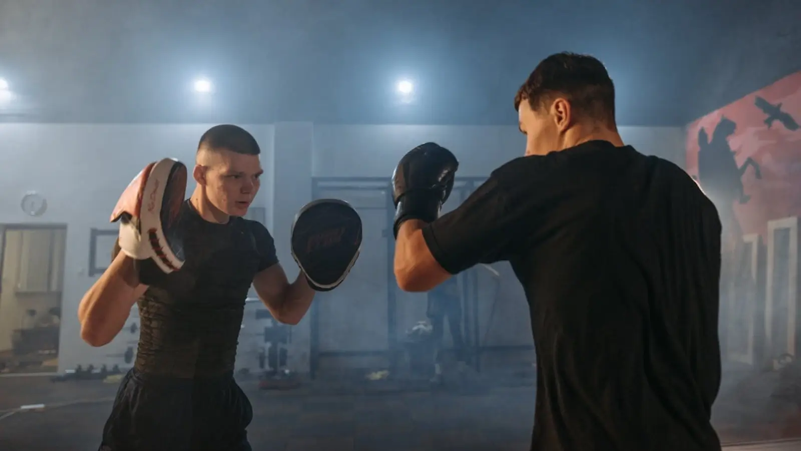 The Evolution of Mixed Martial Arts Mixed martial arts fighters training in a gym under the guidance of a coach