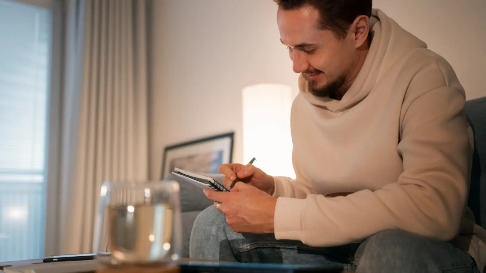 Person reviewing finances on a bank app while planning debt repayment and savings