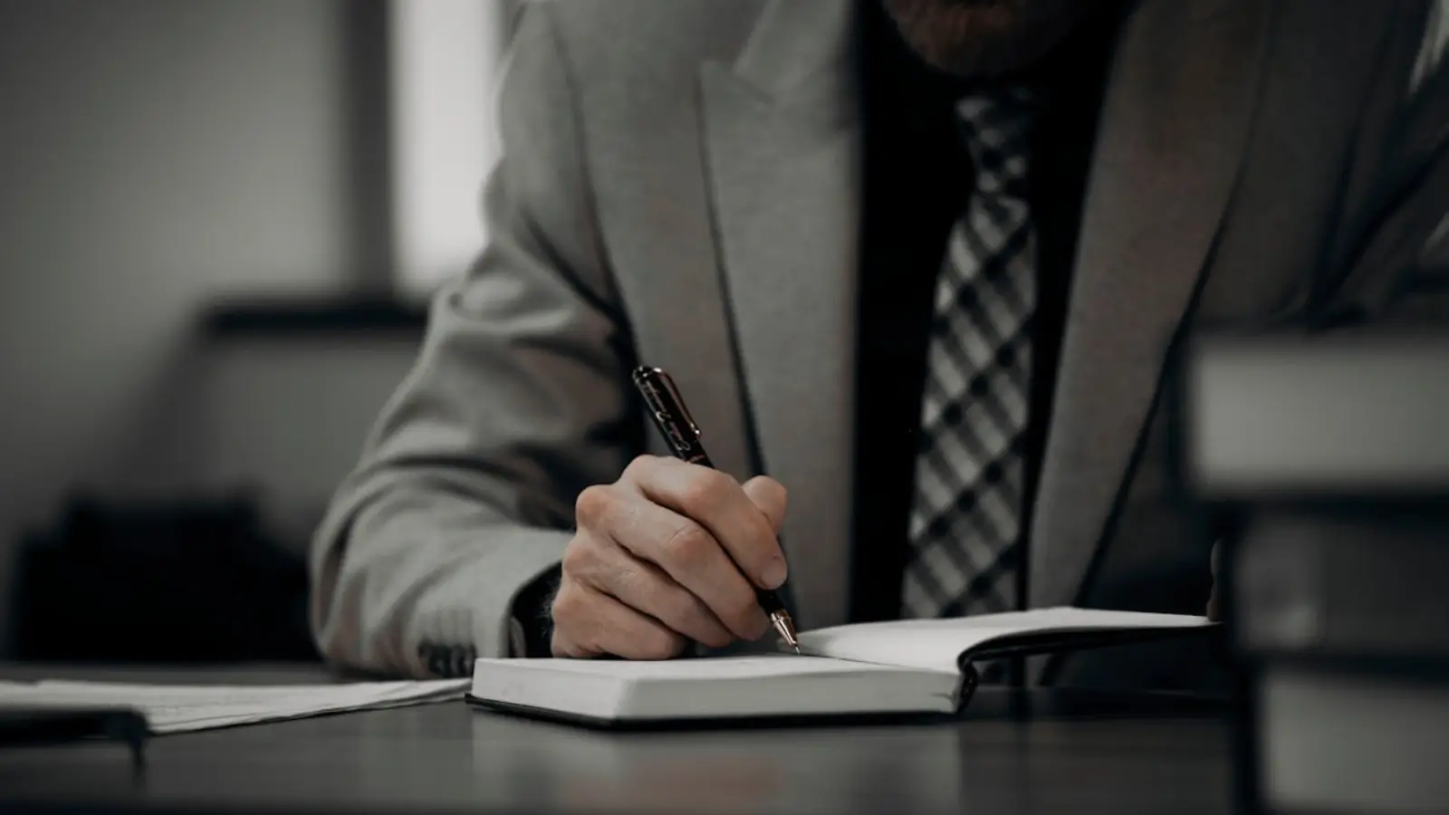 Confident CEO reviewing investment portfolio with charts and financial documents