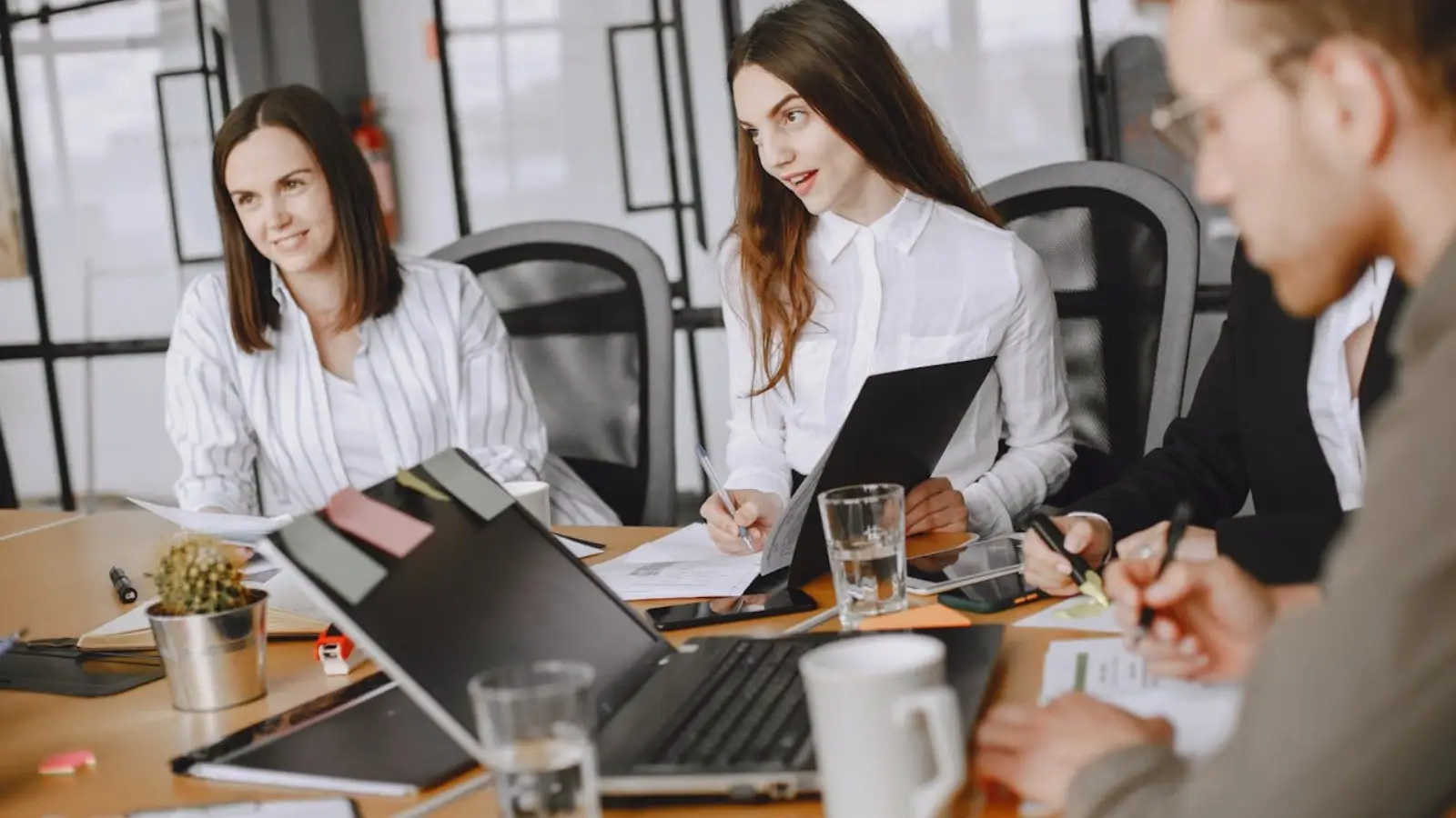 Marketing team managing multiple Facebook ad campaigns on digital dashboard