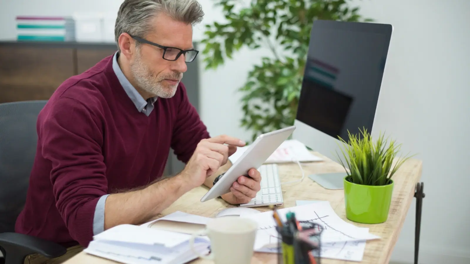 Professional reviewing retirement finances during final working years