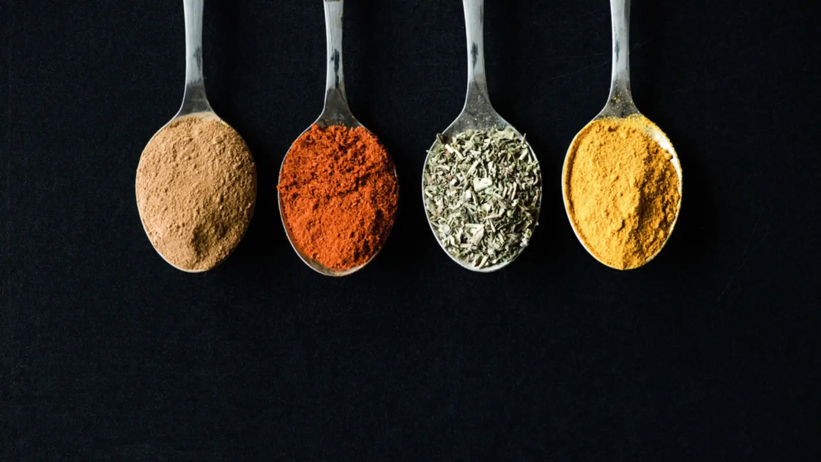 Colorful healthy meal with fresh herbs, spices, and lemon on kitchen table