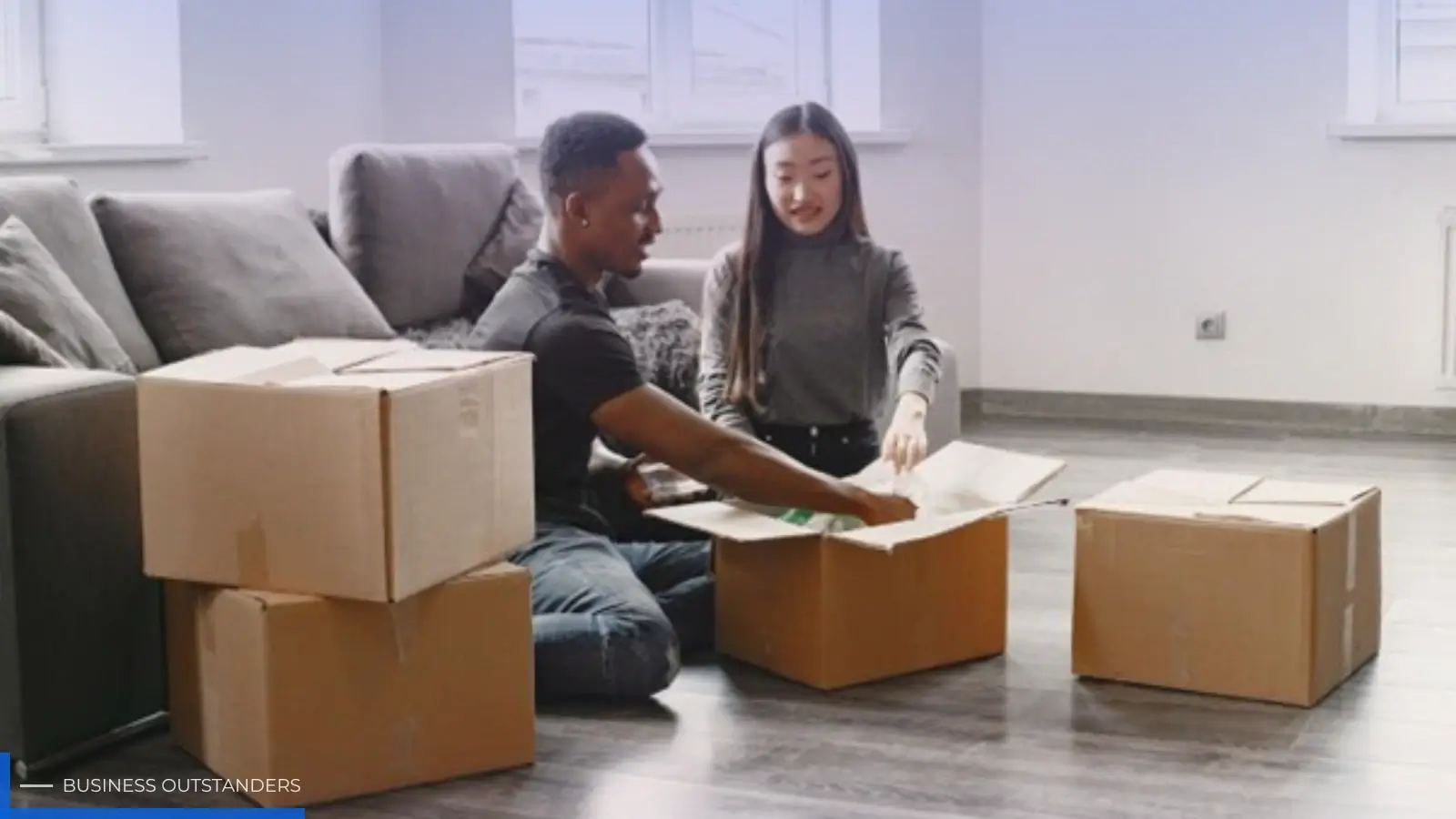 Family planning a budget-friendly move with boxes and packing supplies in living room