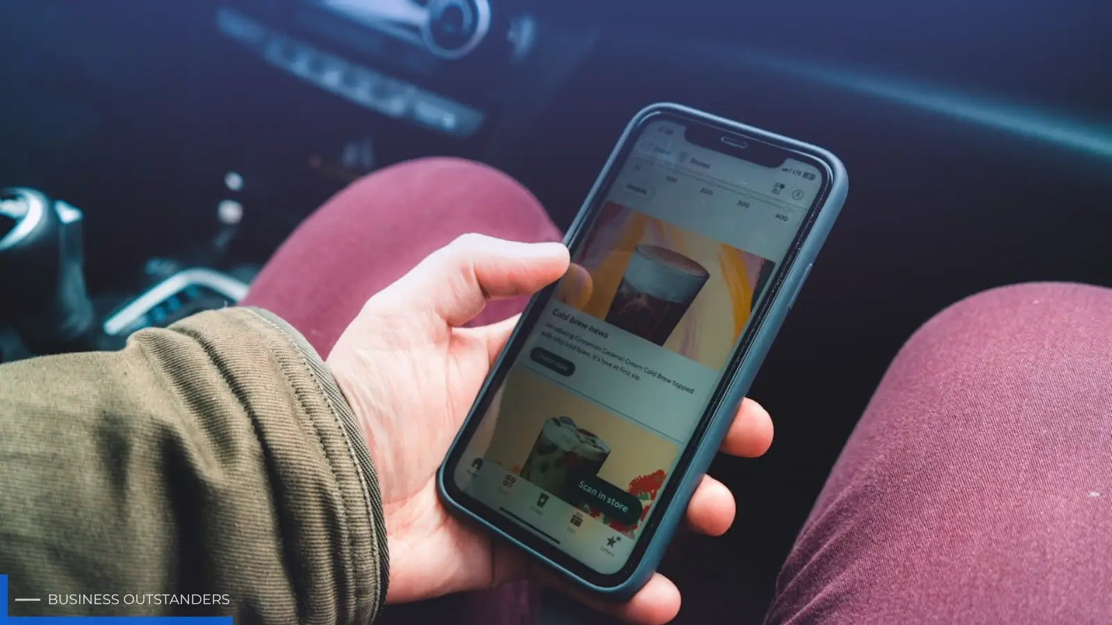 Person browsing a grocery app on a smartphone to search for their favourite branded drink in an online store