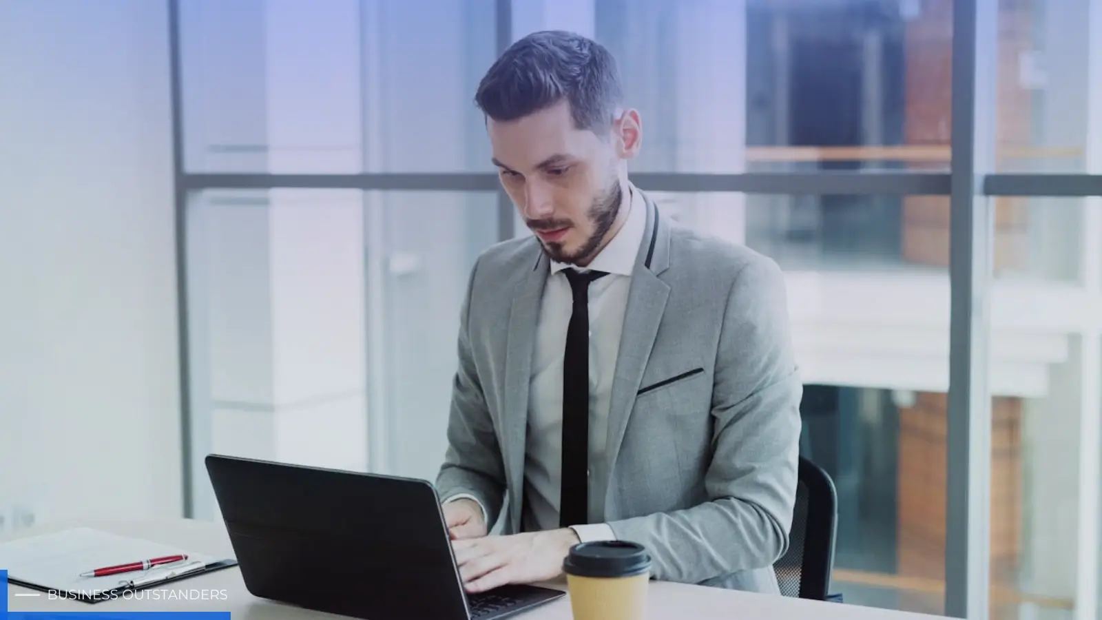 Business professional using e-invoicing software on a laptop in a UAE office setting