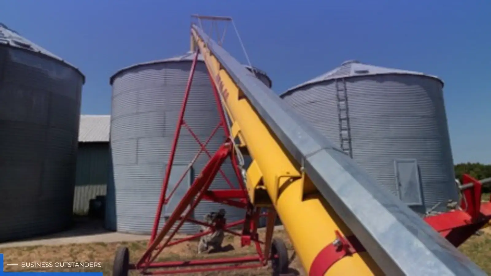 Custom industrial screw conveyor system transporting bulk materials in a manufacturing facility