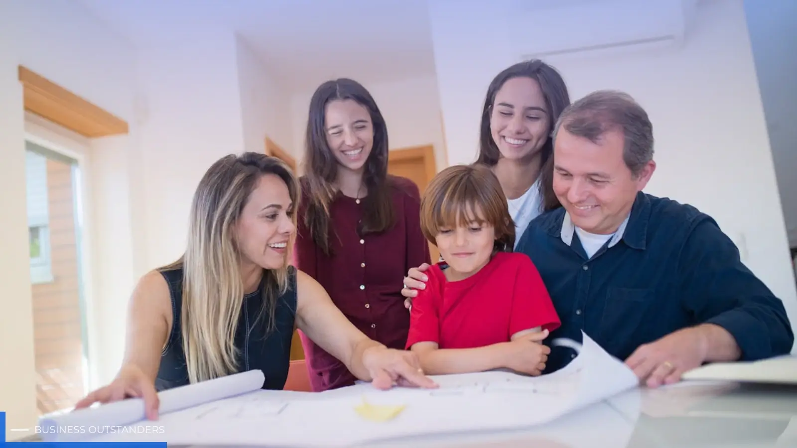 Family reviewing a household emergency plan with evacuation routes and meeting spots marked on a map
