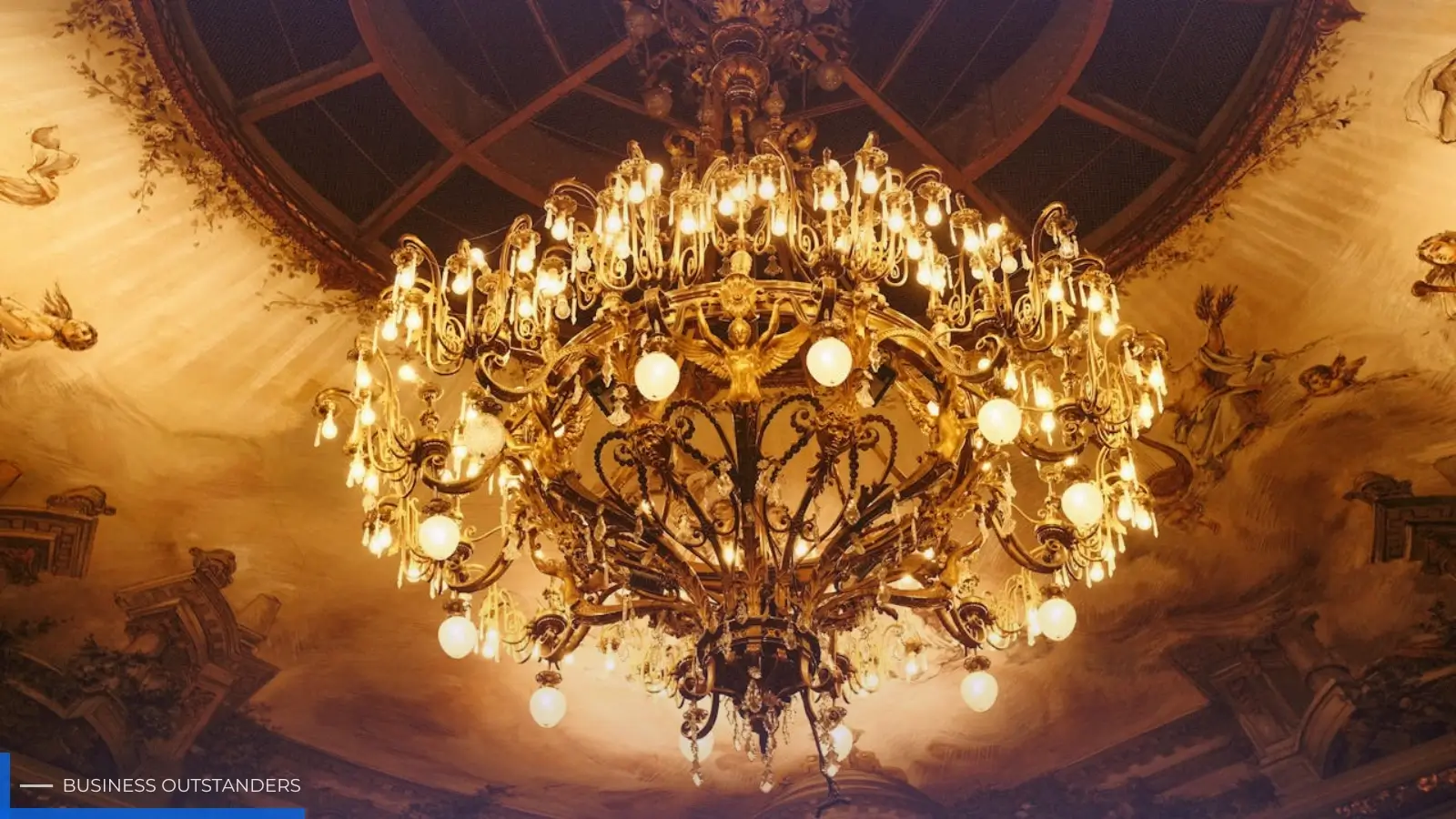 Goldy Singh founder of Sparkle and Shine UAE showcasing a luxury crystal chandelier in a Dubai showroom