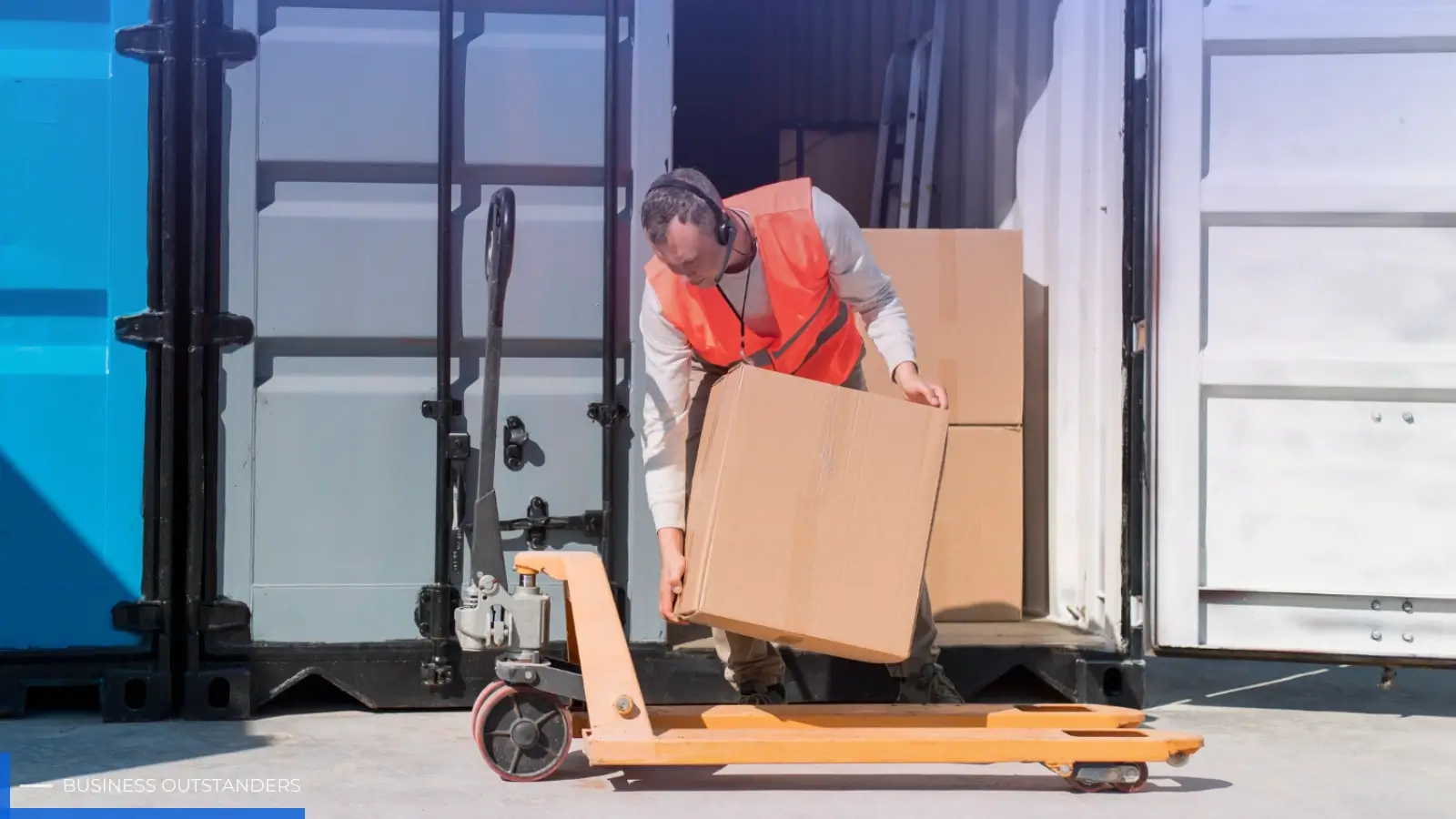 International movers loading boxes into a shipping container for overseas relocation