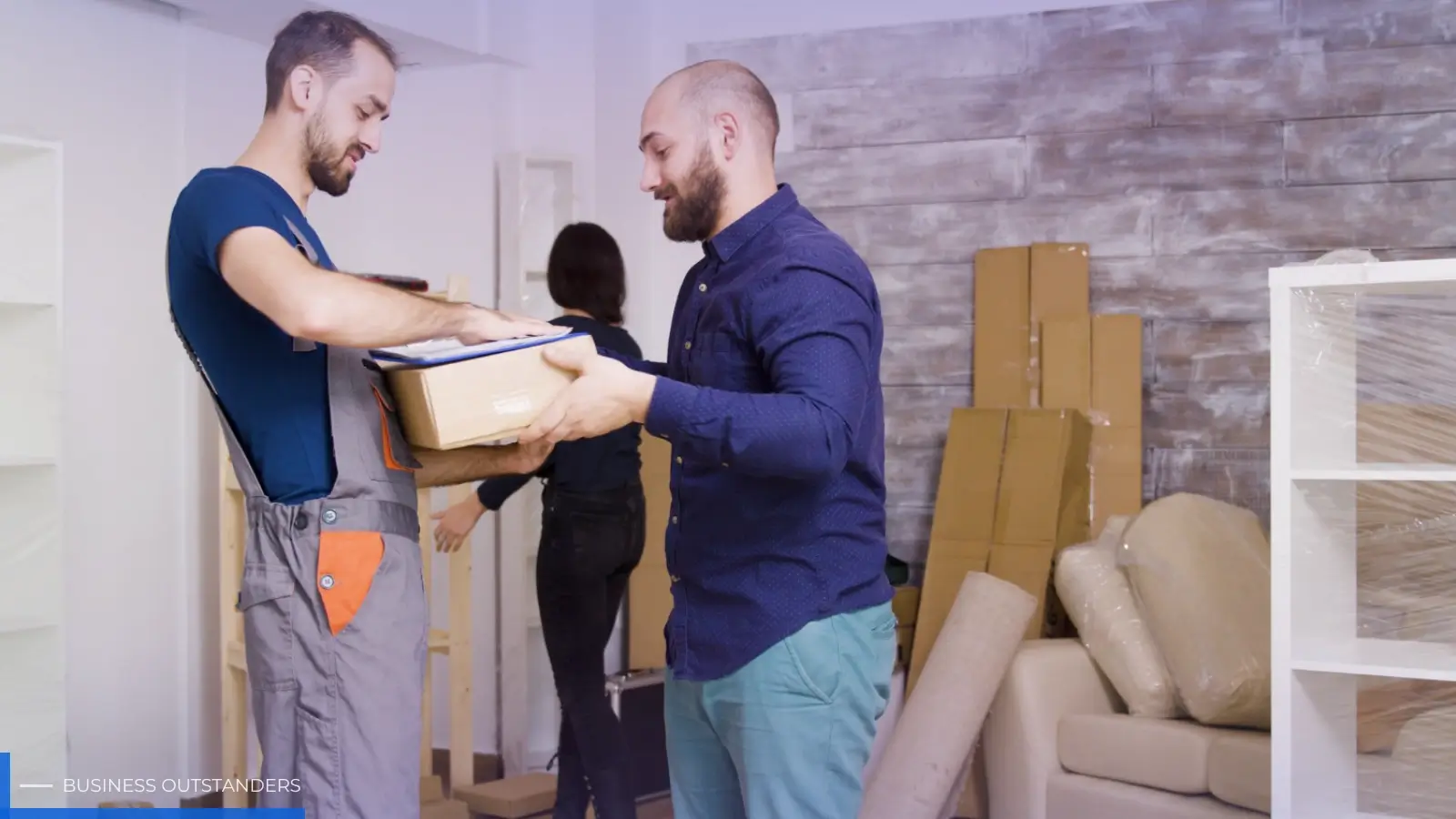 Professional movers carefully transporting office equipment and furniture during a commercial office relocation