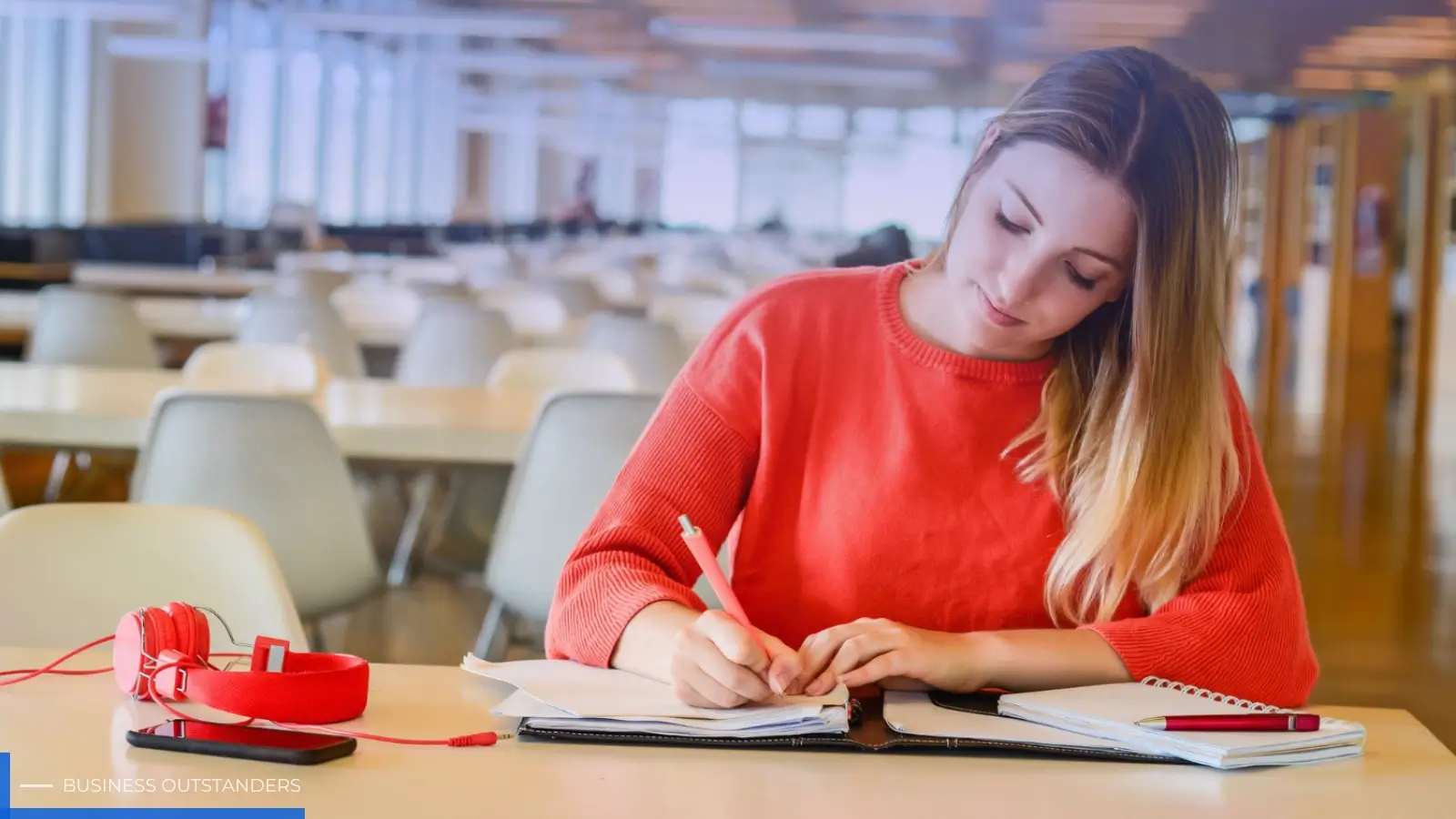 Student studying for CFA Level 1 exam in 2026 with books and study schedule
