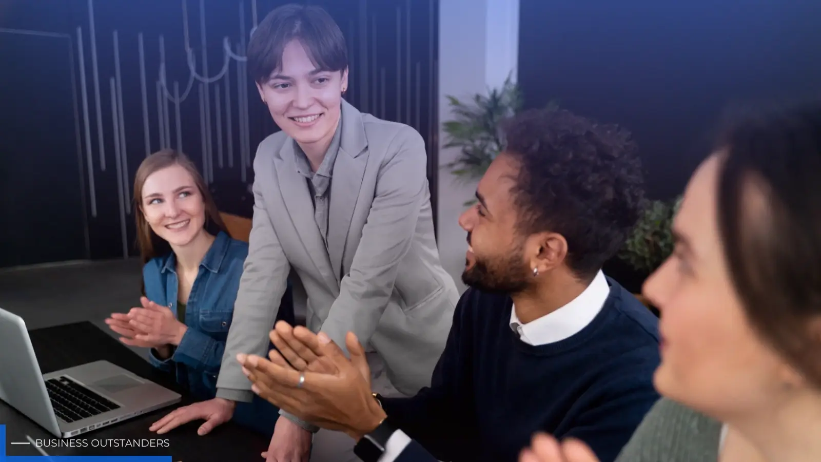 A business leader demonstrating effective people management skills while engaging with a diverse team in a modern workplace
