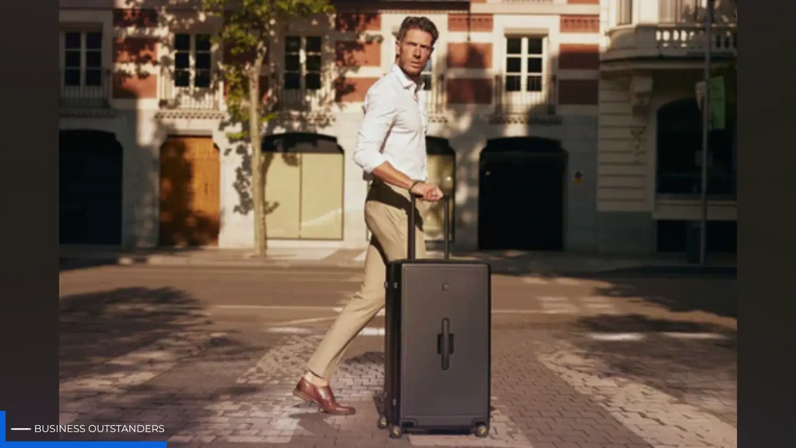 A sleek carry-on suitcase beside a minimalist capsule wardrobe laid out for a design-led city break