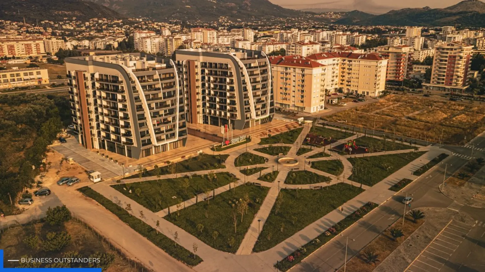 Aerial view of a master-planned real estate development with neighborhoods, greenways, and commercial hubs